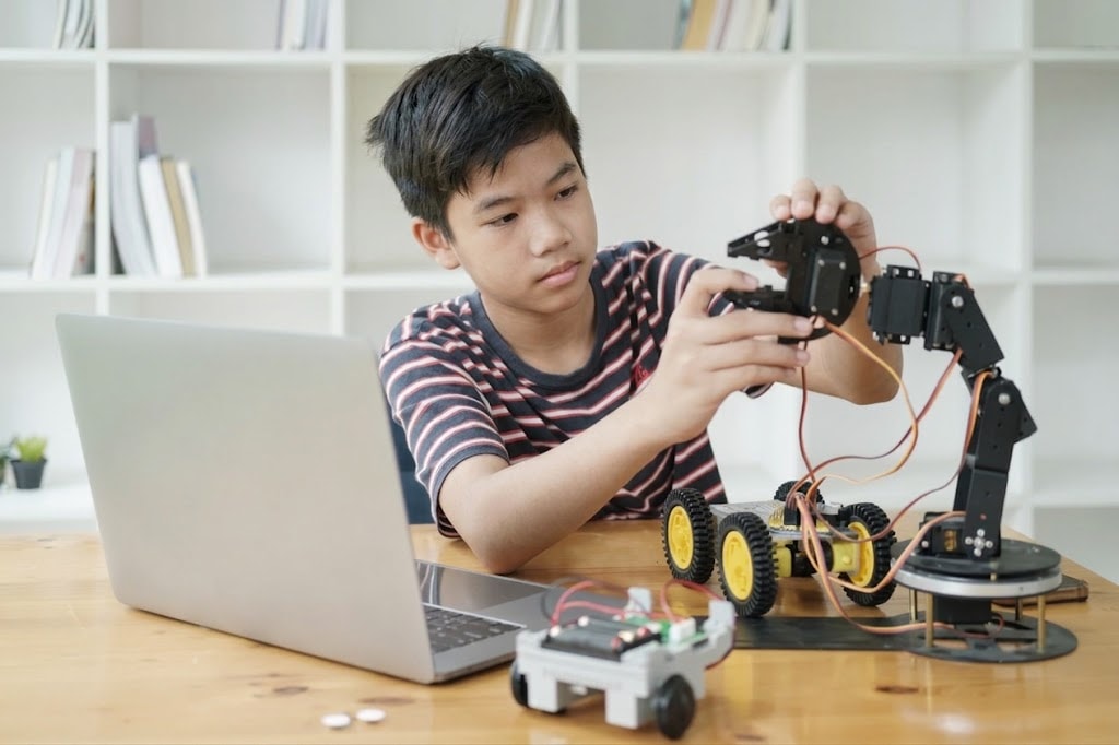 A student building a robot at ROBOX