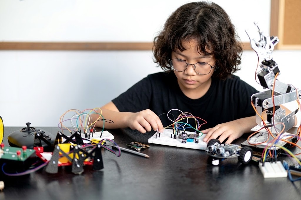 A student building a robot at ROBOX
