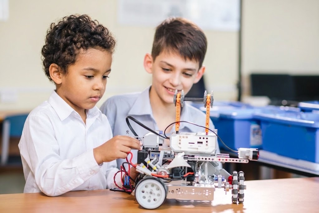 A student building a robot at ROBOX